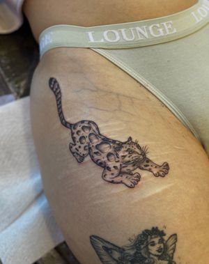 Transform your scars into fierce art with this illustrative leopard tattoo by Julia Bertholdi.