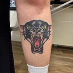 Get a bold and timeless traditional panther tattoo done by the talented artist Laurel. Embrace your wild side with this fierce design.