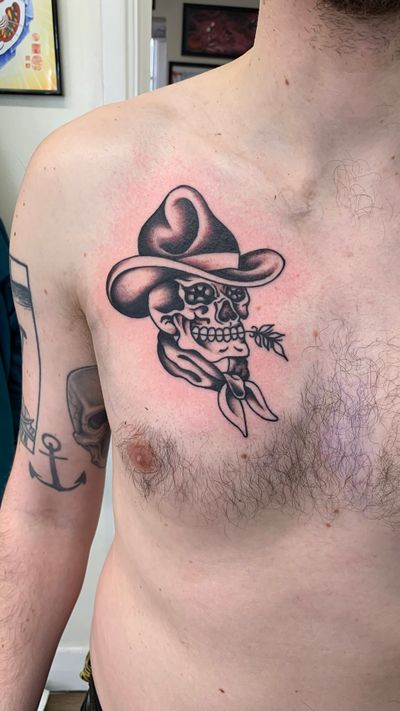 Experience the wild west with this bold traditional tattoo featuring a skull cowboy motif, expertly crafted by Laurel.