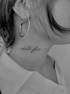 Discover the beauty of small, intricate lettering with this fine line tattoo by the talented artist Ruth Hall.