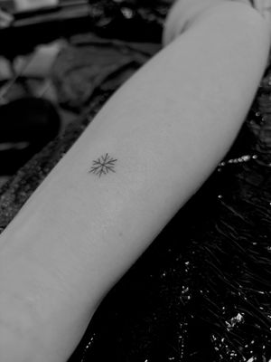 Explore the delicate beauty of fine line art with this exquisite snowflake tattoo by renowned artist Ruth Hall.