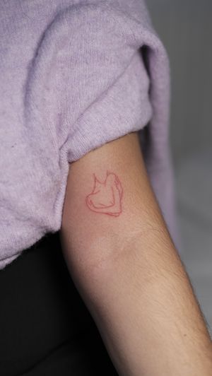Embrace self love with this unique fine line hand poke tattoo featuring a woman in red ink. Created by talented artist Anna.
