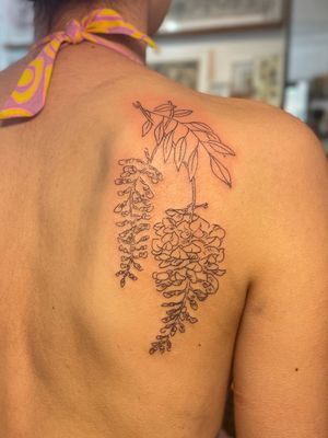 Adorn your skin with a delicate fine line and illustrative branch tattoo, expertly created by the talented artist Julia Bertholdi.