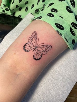 Elegant fine line butterfly tattoo design by renowned artist Julia Bertholdi, a perfect choice for a subtle and stylish statement.