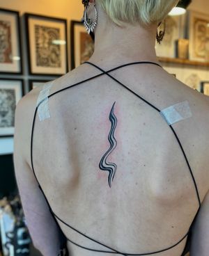 Embrace the fluidity of life with this wavy, curvy blackwork tattoo design by the talented artist Julia Bertholdi. Make a bold statement with this unique and abstract piece.