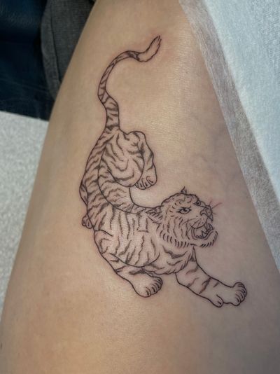 Experience the power of the jungle with this fine line tiger tattoo. Julia Bertholdi's expert artistry brings this majestic creature to life.