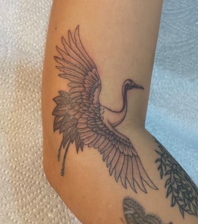 Elegantly detailed dotwork tattoo of a heron by tattoo artist Julia Bertholdi. This illustrative design captures the beauty of this majestic bird.
