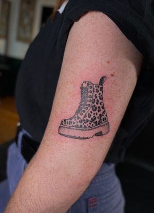 Unique tattoo by Julia Bertholdi featuring a stylish boot with animal print design.