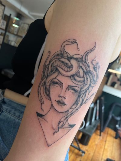 Capture the mythical allure of Medusa with this stunning illustrative tattoo by renowned artist Julia Bertholdi.