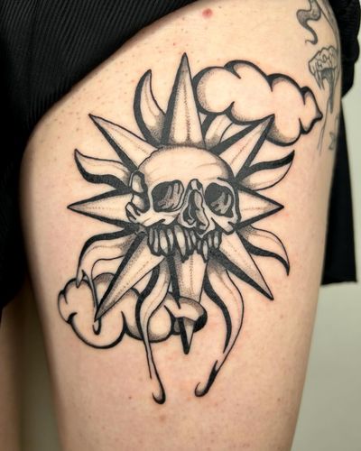 Embrace the beauty of life and death with this striking blackwork tattoo featuring a sun and skull motif, expertly executed by tattoo artist Jack Howard.