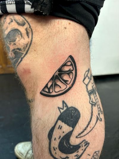 Get a refreshing burst of color with this blackwork tattoo featuring slices of lemon, lime, and orange by talented artist Jack Howard.