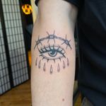 Get a striking illustrative traditional tattoo featuring a barbed wire, eye, and tears design by Julia Bertholdi.