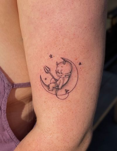 Get bewitched by Julia Bertholdi's illustrative tattoo featuring a mystical moon intertwined with a devilish figure.