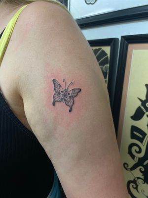 Experience the delicate beauty of an illustrative butterfly tattoo by renowned artist Julia Bertholdi.