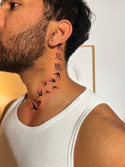 Unique blackwork tattoo by Ion Caraman featuring a striking combination of a bird, shadow, and elegant kanji lettering.