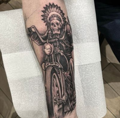Explore the powerful fusion of indigenous culture and biker subculture in this striking black and gray illustrative tattoo by Sam Waiting.