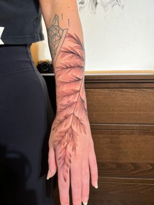 Explore the delicate beauty of nature with this black and gray illustrative fern tattoo by the talented artist Ion Caraman.
