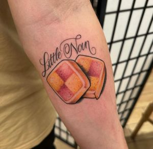 Unique small lettering candy tattoo by Sam Waiting, combining illustrative elements for a whimsical touch.