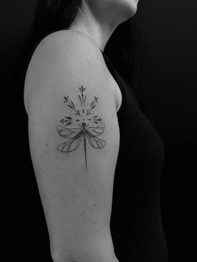 Experience the delicate beauty of a dragonfly with this fine line ornamental tattoo by artist Oliver Soames. Perfect for those seeking a unique and elegant design.