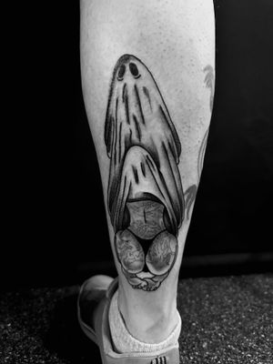 Get spooked with this illustrative tattoo of a sheet ghost and woman by the talented artist Oliver Soames. Perfect for fans of spooky and feminine ink.