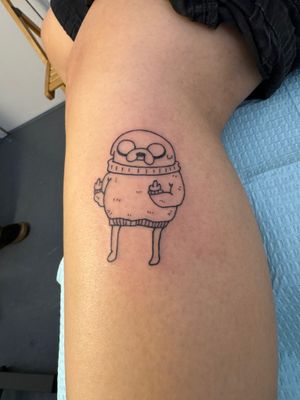 Get inked with this fantastic illustrative tattoo of Jake from Adventure Time by Ronny East. Show off your love for the adventurous dog!