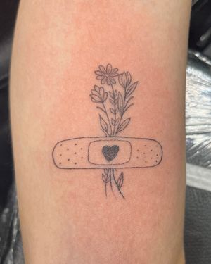 Beautiful tattoo design by Ronny East featuring a flower, heart, and band aid motif in illustrative style.