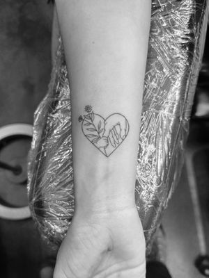 Get a beautifully intricate fine line heart tattoo symbolizing love for family by Ronny East.