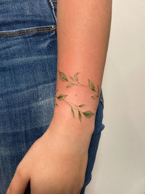 Illustrative tattoo by Ronny East featuring a delicate botanical vine design, perfect for nature lovers.