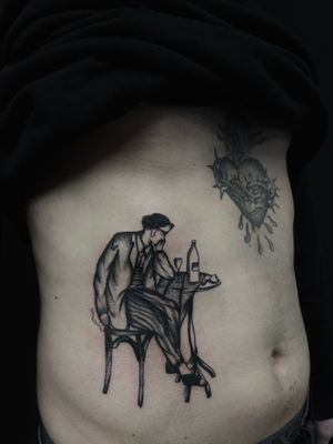 Traditional tattoo by Ludo Matmut showcasing a French man sitting at a table.