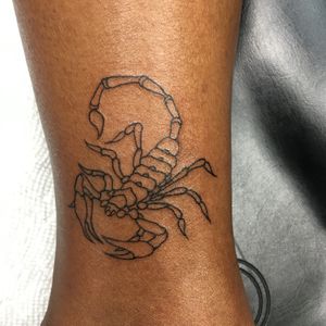 Illustrative scorpion tattoo by Ronny East showcasing intricate details and precise lines.