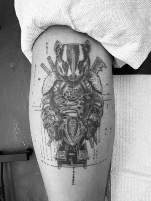 Bold illustrative style tattoo combining samurai warrior and badger motif, by talented artist Ronny East.