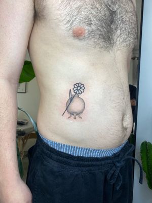 Get a unique black and gray tattoo of a flower in a vase by talented artist Charlie Macarthur.