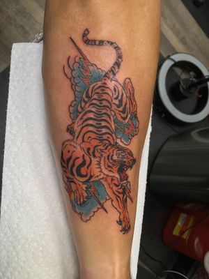 Immerse yourself in the power and beauty of Japanese tradition with this fierce tiger tattoo by the talented artist Ronny East.