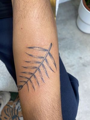 Black and gray tattoo featuring a detailed branch design. Unique and artistic tattoo work by renowned artist Charlie Macarthur.
