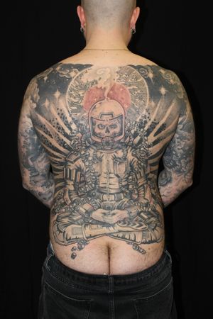 Unique illustrative tattoo featuring an astronaut and a skull, expertly designed by Stewart Robson.