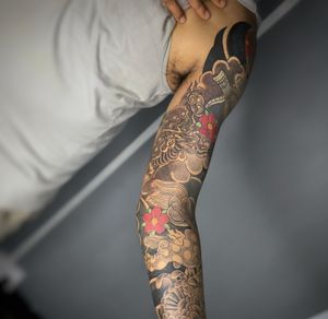 Full arm tebori tattoo of foodog and kirin 