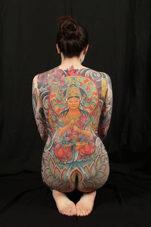 Experience the spiritual essence with this intricate Japanese tattoo featuring a depiction of Buddha and deity by master artist Stewart Robson.