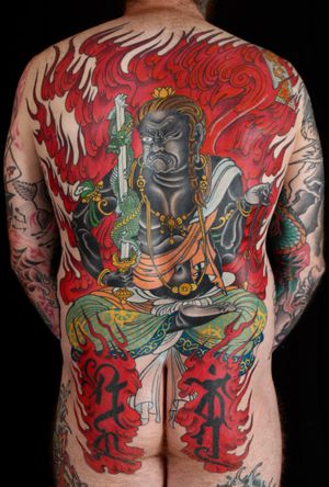 Experience the power of Stewart Robson's skill in this striking Japanese tattoo featuring a dragon and Fujin, the god of wind.