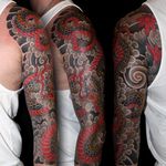 Get inked by the master artist Stewart Robson with this striking Japanese style tattoo featuring a fierce snake entwined in smoke.