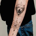 Explore the mystical world of Norse mythology with this stunning fine line and geometric tattoo of a wolf intertwined with runic symbols. By talented artist Gabriele Edu.