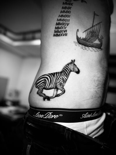 Capture the beauty of a zebra with this stunning black and gray realism tattoo by the talented artist Georgina.