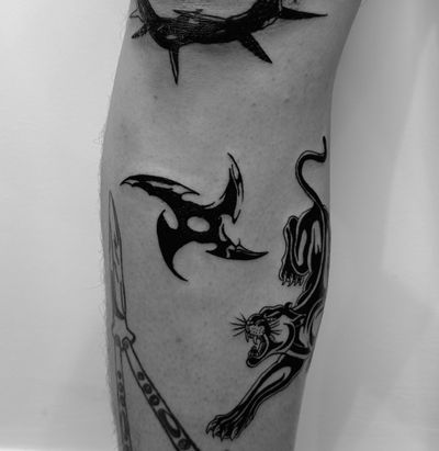 Exquisite blackwork design featuring a fierce panther and traditional shuriken done by the talented artist Oliver Soames.