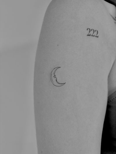 Experience the beauty of a fine line moon tattoo by Ruth Hall, capturing the magic of the night sky in a delicate design.