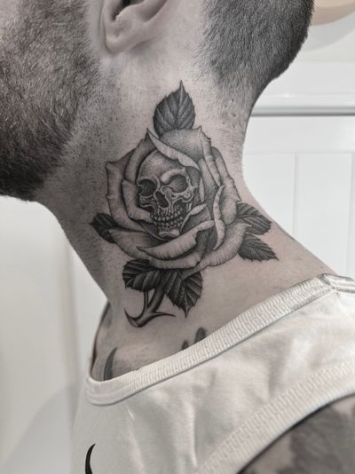 Black and grey fineline skull in a rose 