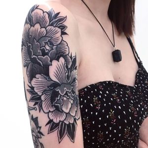 Get a stunning floral design by Giada Knox, using intricate blackwork and dotwork techniques for a unique and bold tattoo.