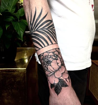 Beautiful blackwork tattoo by Giada Knox featuring intricate floral vine design. Perfect for a striking arm band look.