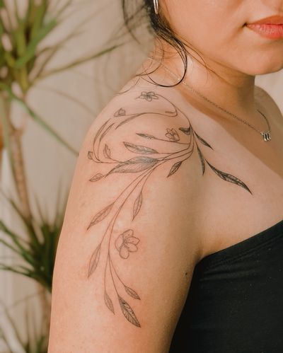 Fine line leaves/vines and cherry blossoms wrapped around the shoulder 