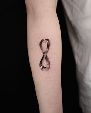 Gorgeous black and gray micro realism tattoo by Gloria Gu featuring a chrome metallic infinity symbol.