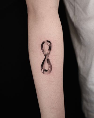 Gorgeous black and gray micro realism tattoo by Gloria Gu featuring a chrome metallic infinity symbol.