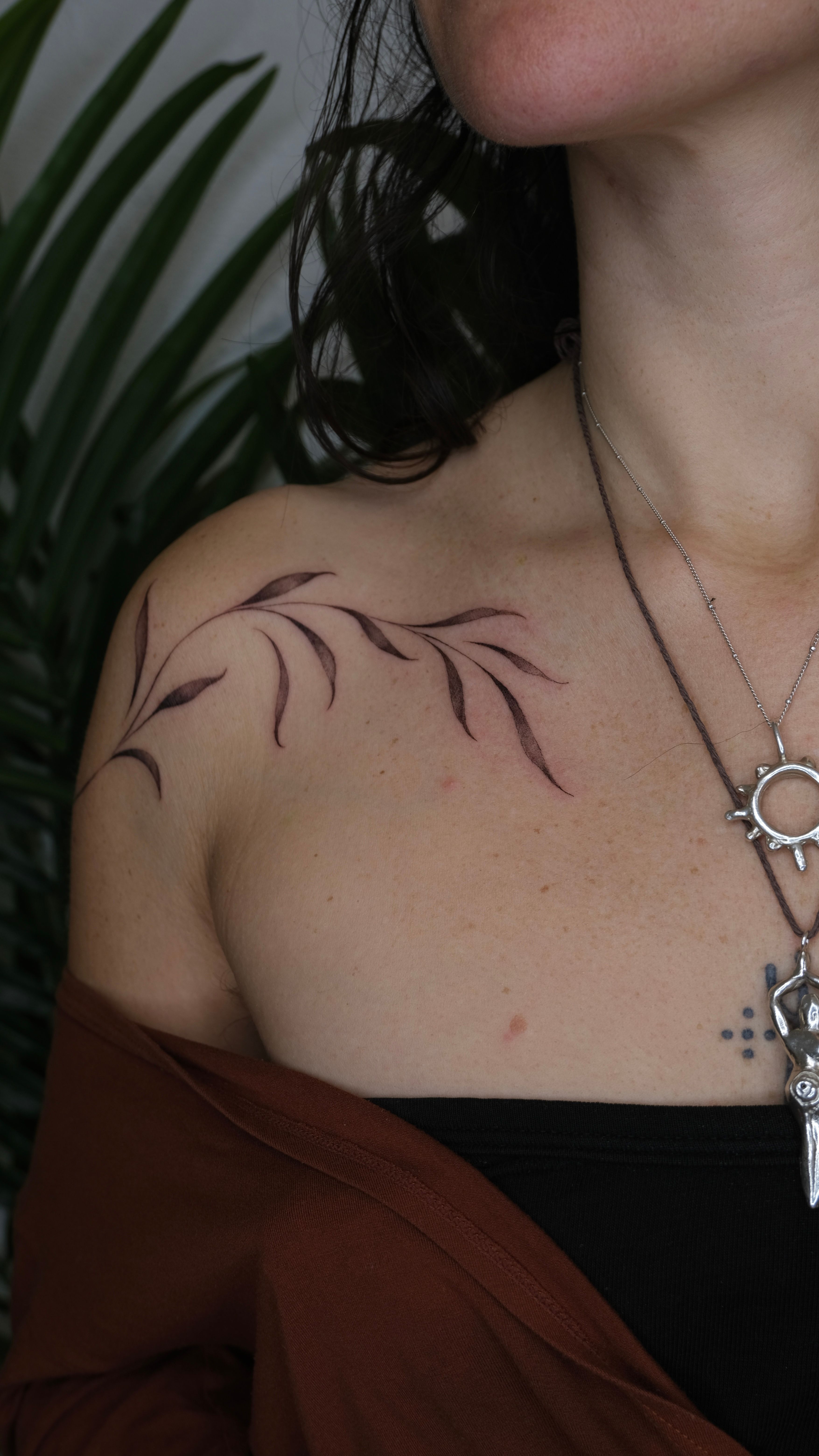 Watercolor phoenix tattoo on the collarbone.